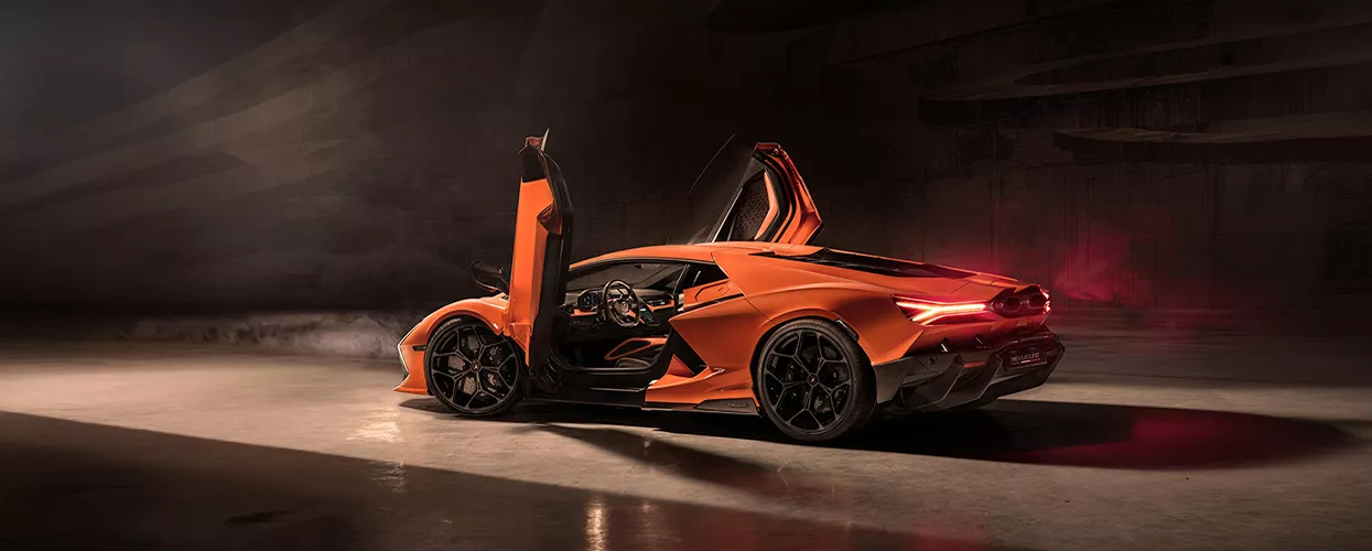 Lamborghini vehicle parked in a garage with the doors open