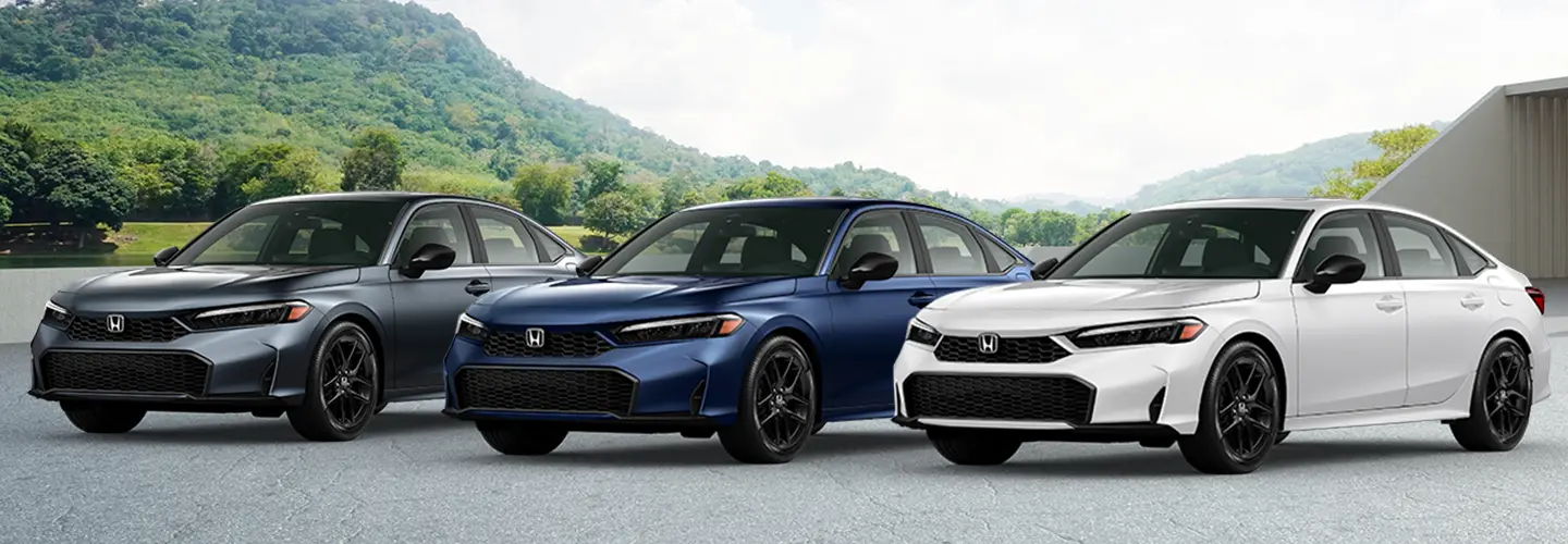 three brand new Honda vehicles with landscape in background