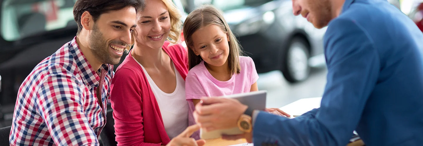 family in new car showroom