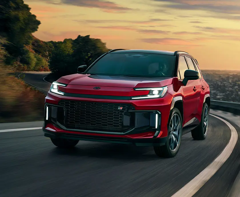 red RAV4 curving around a loopy road