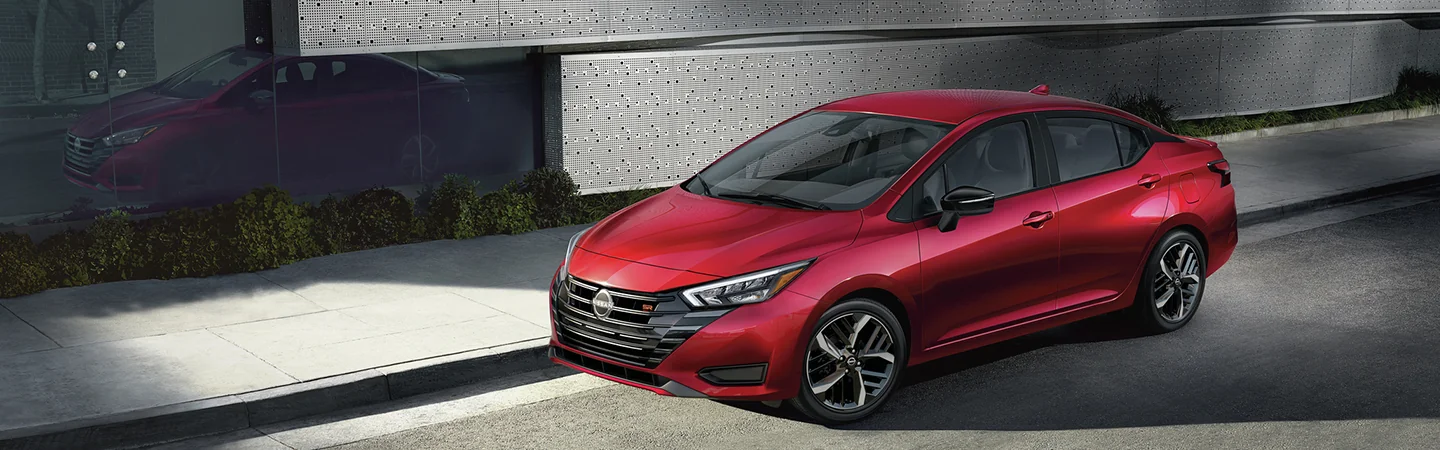 red 2025 Nissan Versa SV parked in the city