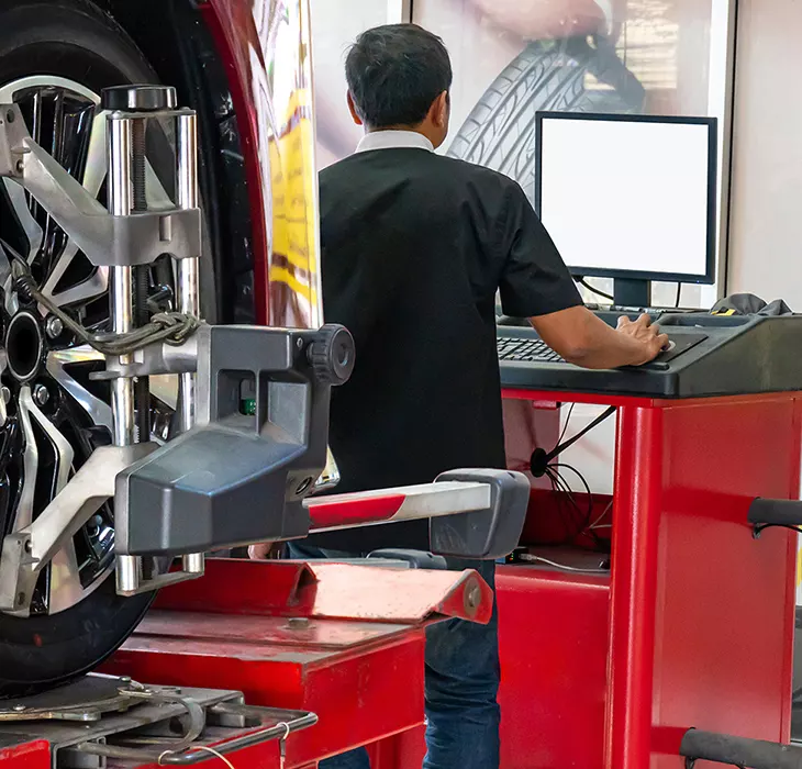 Technician servicing a vehicle