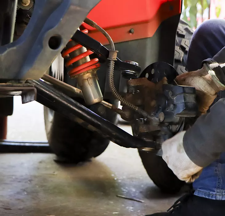 Technician servicing a Wood Powersports Harrison vehicle
