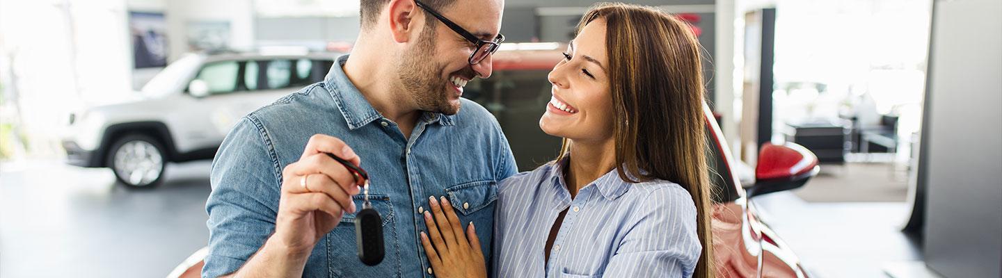 A couple celebrating their new car purchase