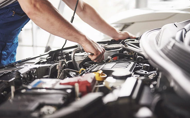 Person working on car engine