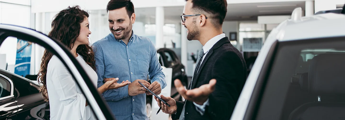 Car salesman speaking with a customer about financing a new Hyundai
