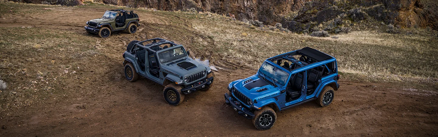1 blue, 1 green, and a gray 2025 Jeep Wrangler Sports with doors off
