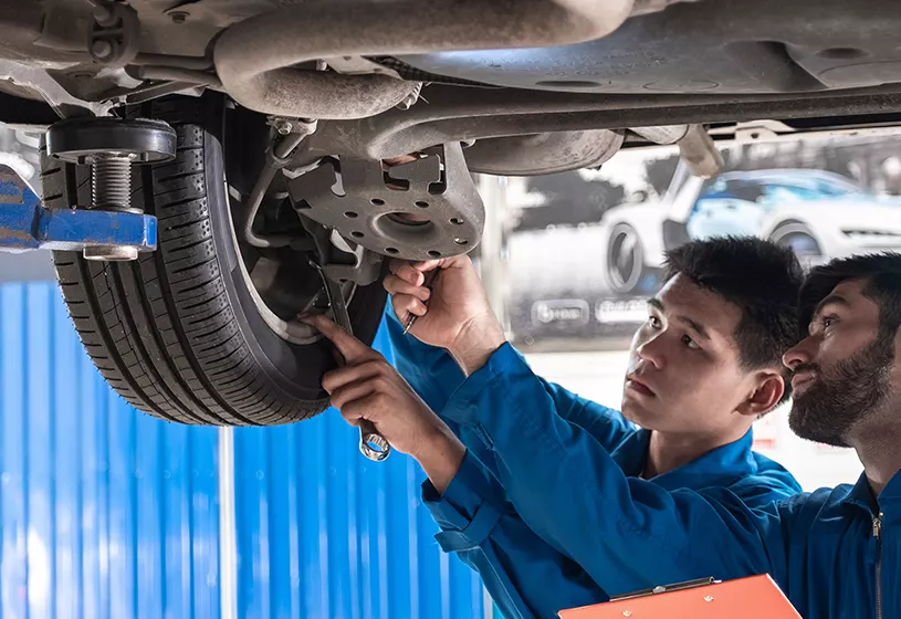 2 Service advisor looking at a wheel