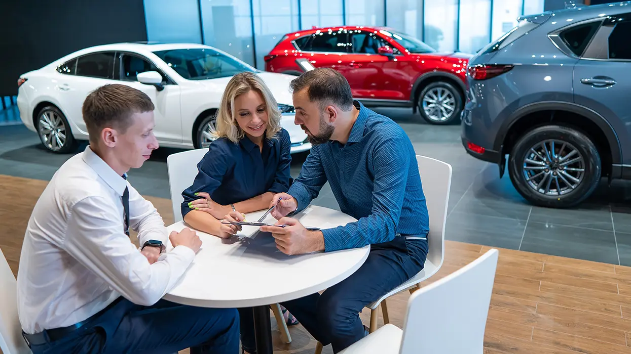 couple consulting on new car