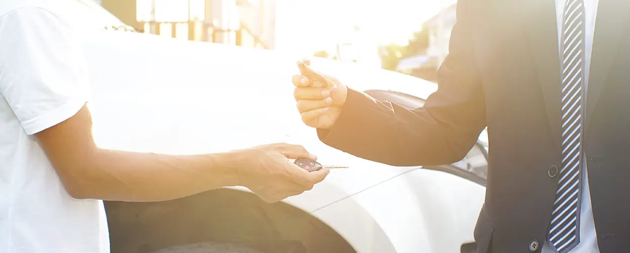 getting keys to new car in showroom
