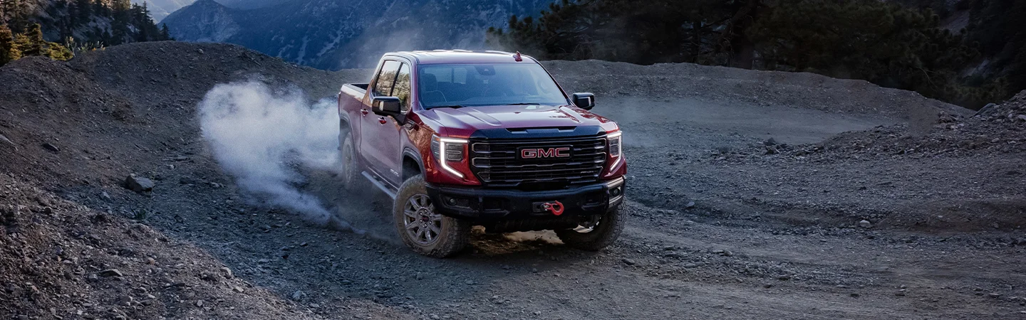 front of red GMC Sierra 1500