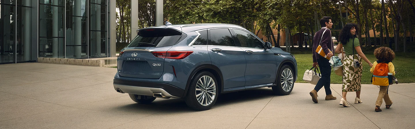Blue 2025 INFINITI QX60 family parked car front of park