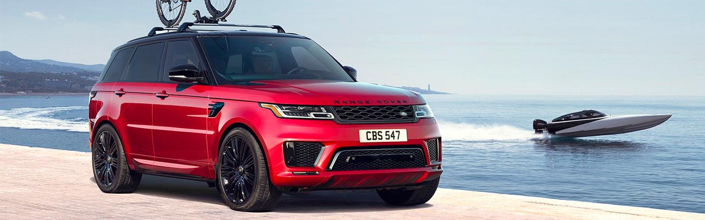 Red Range Rover near the ocean