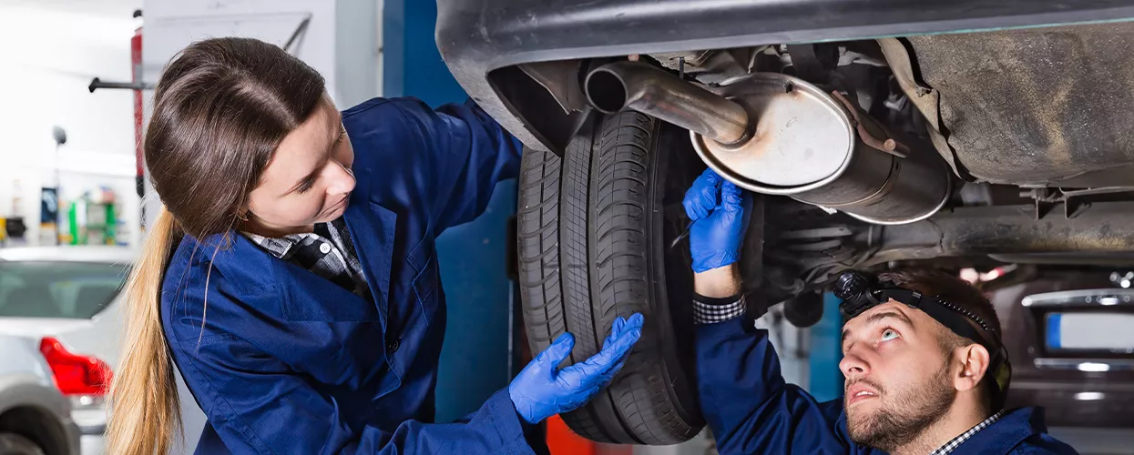 Audi technician performing routine maintenance in a service bay near Clearwater, Florida