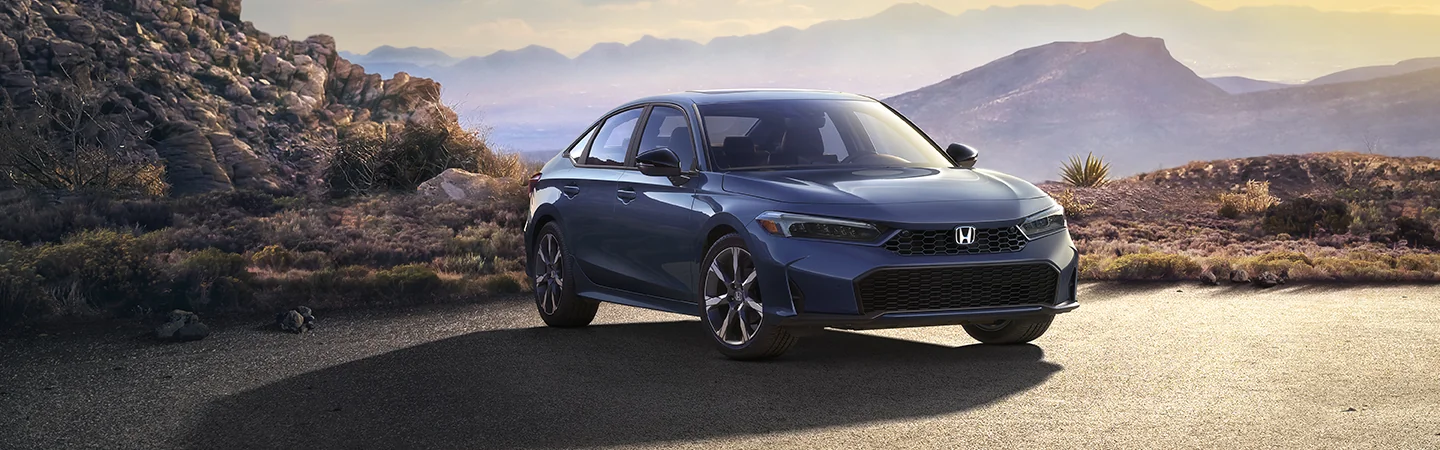 Front view of a parked 2025 Honda Civic Sport with mountains in the background