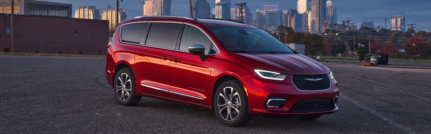 Front angle view of the 2026 Chrysler Pacifica parked in front of a city skyline