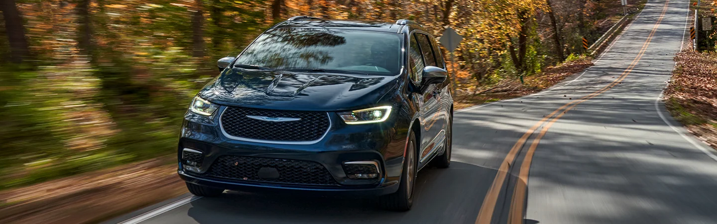 2026 Chrysler Pacifica driving on a country road in the fall