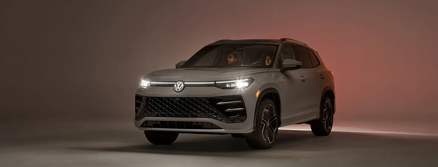A gray 2025 Volkswagen Tiguan parked with 2 people in it