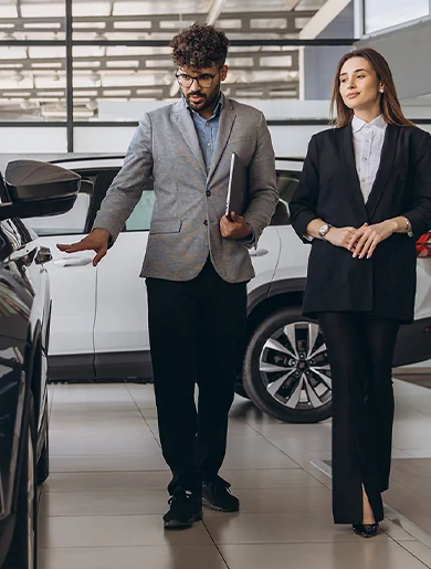 couple in car service bay checking out vehicles