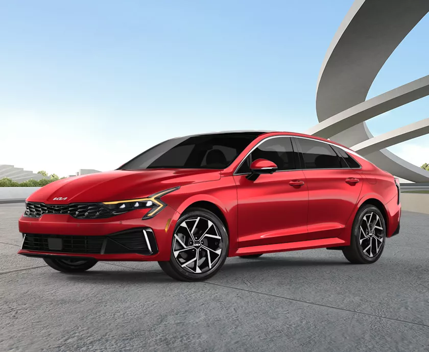 Front side view Of a parked red 2026 Kia K5