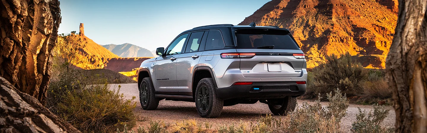 2025 Jeep Grand Cherokee Sliver color car back view on road 
