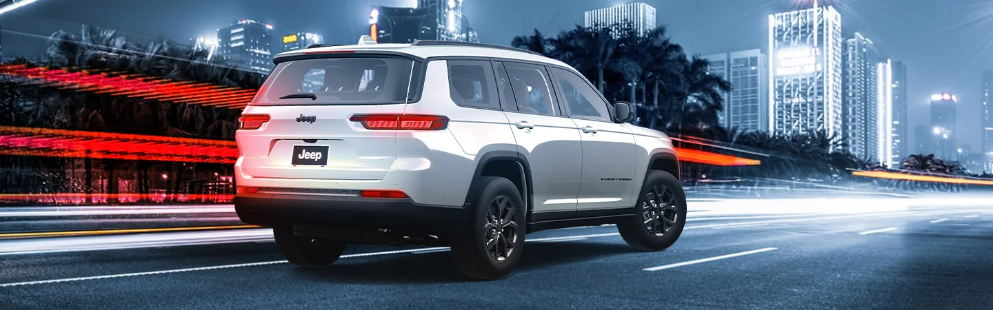 2025 Jeep Grand Cherokee Sliver color car back view on city road