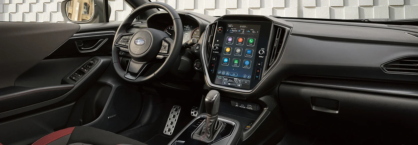 Interior view of the front seat and dashboard and tech of a 2025 Subaru Impreza in Leesburg, FL.