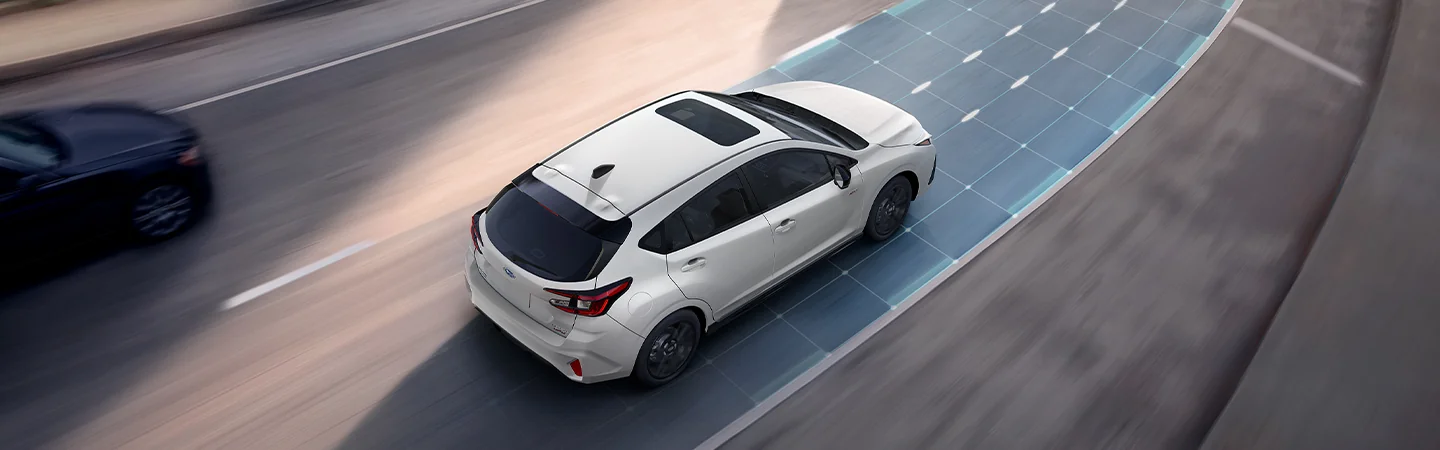 Top view of a White 2025 Subaru Impreza driving on a freeway showing off the lane assist in Leesburg, FL.