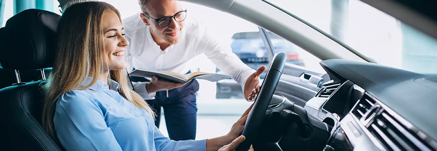 Car salesman showing someone a new vehicle