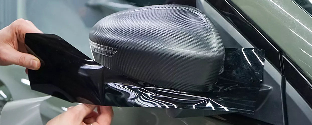 Carbon Mirror cap being put on a car mirror