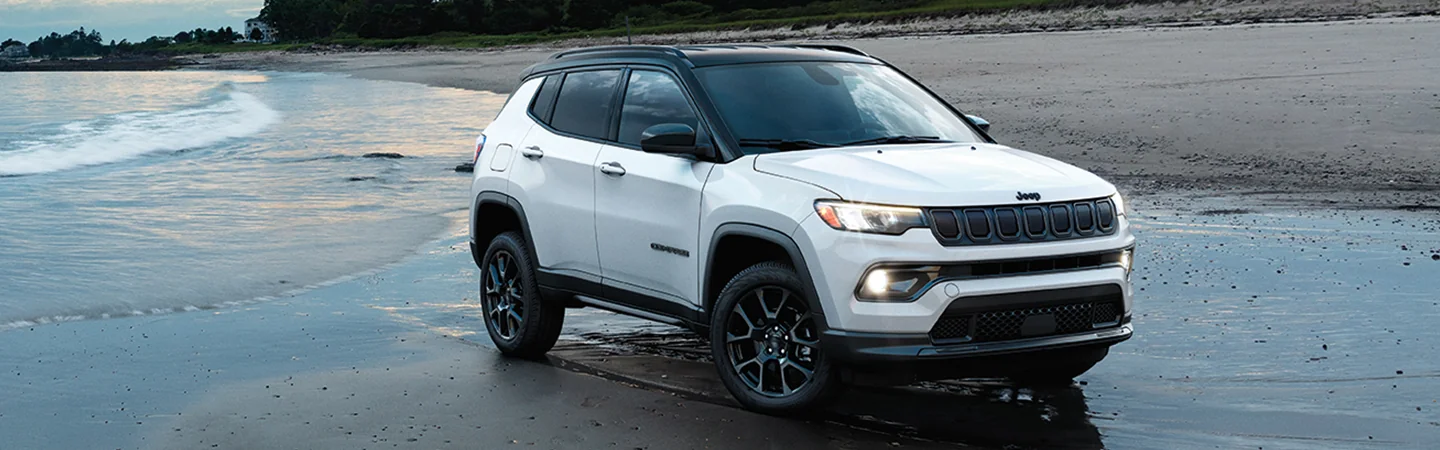 white 2025 Jeep Compass parked at beach