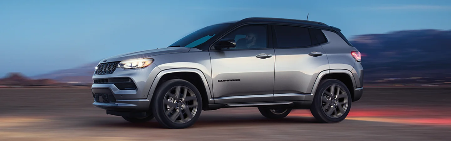 gray 2025 Jeep compass driving on highway