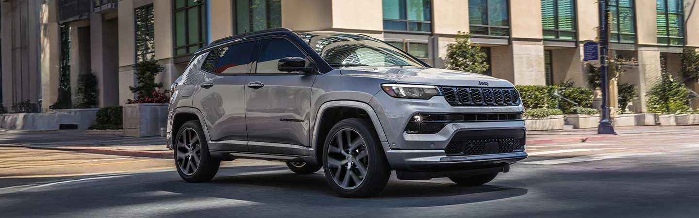 gray 2025 Jeep Compass driving in a city