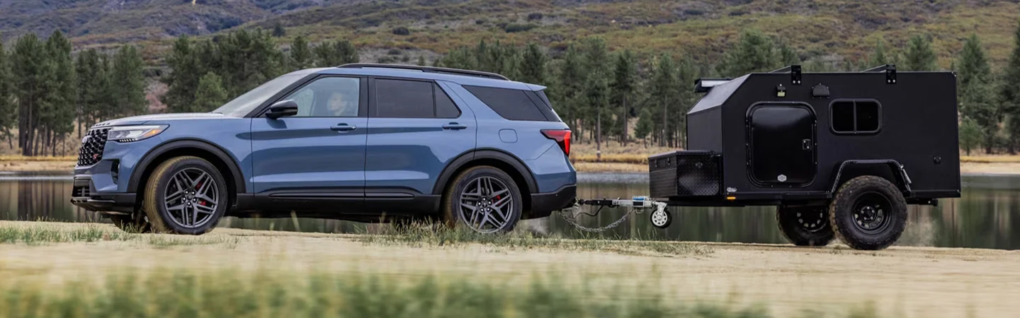 2025 Ford Explorer vs 2024 Chevrolet Traverse front side in blue