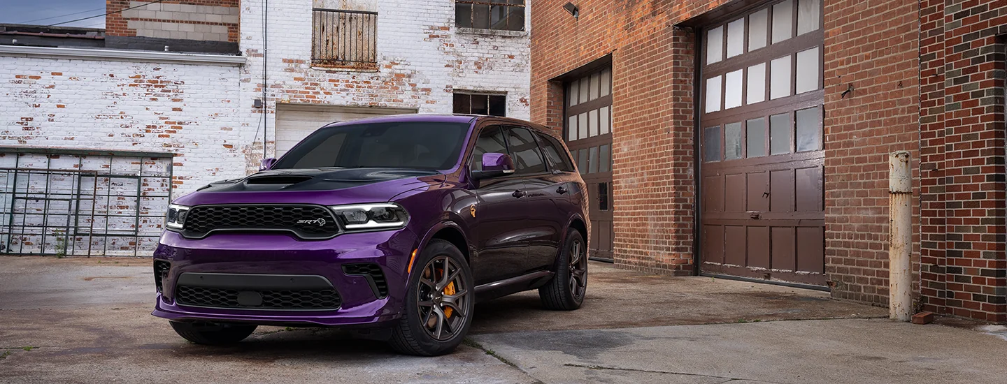 Front view of a purple 2026 Dodge Durango parked by some wherehouses