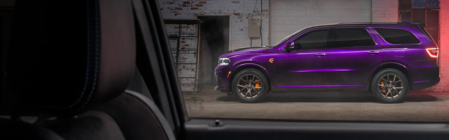 Side view of a parked purple 2026 Dodge Durango though a window