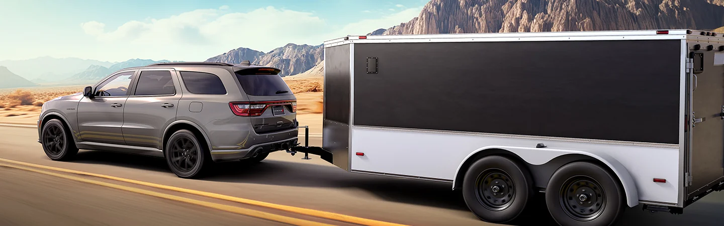 A gray 2026 Dodge Durango pulling a trailer