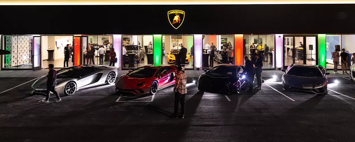 Lamborghini vehicles displayed at a dealership at night