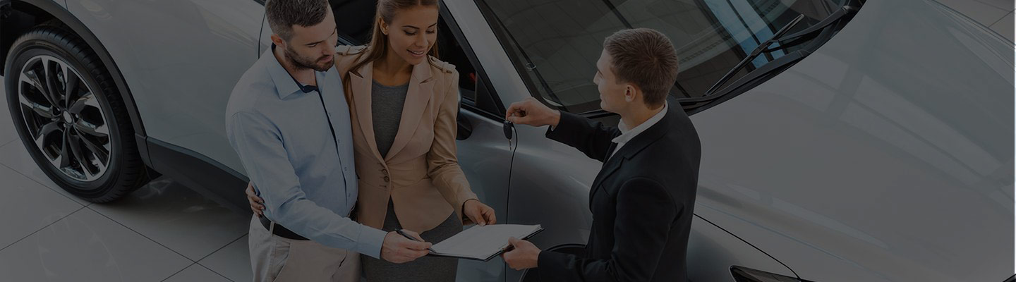 Couple talking with car salesman