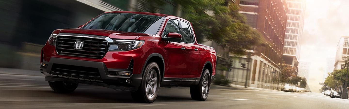 2021 red Ridgeline driving downtown