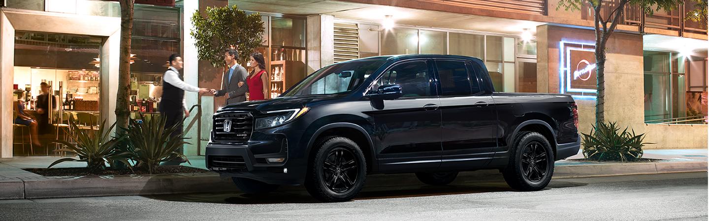 Couple valet parking their black 2021 Nissan Ridgeline