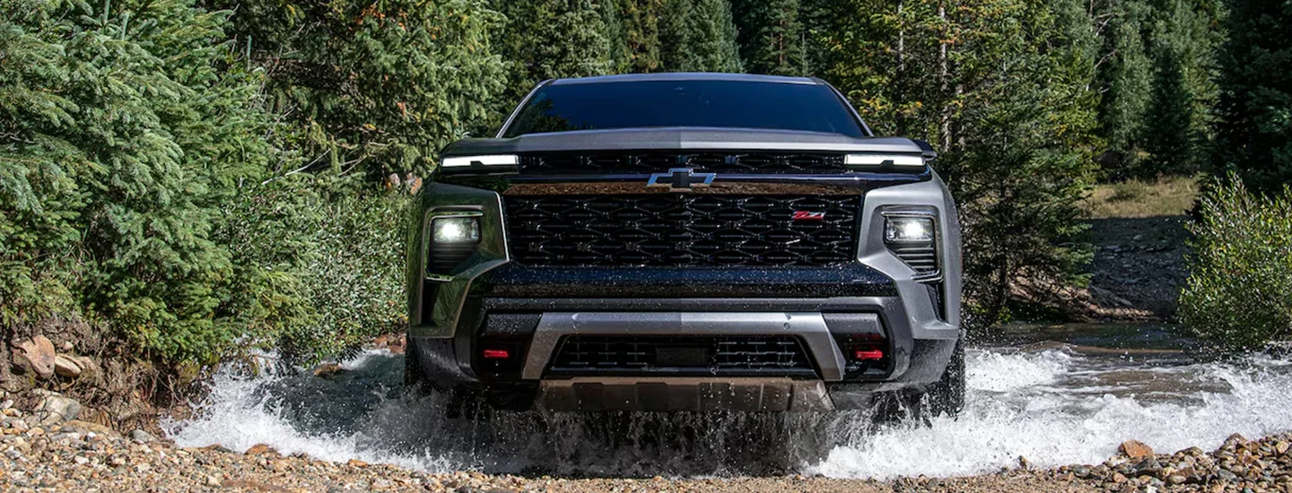 Front view of a2024 Chevrolet Traverse driving though a river
