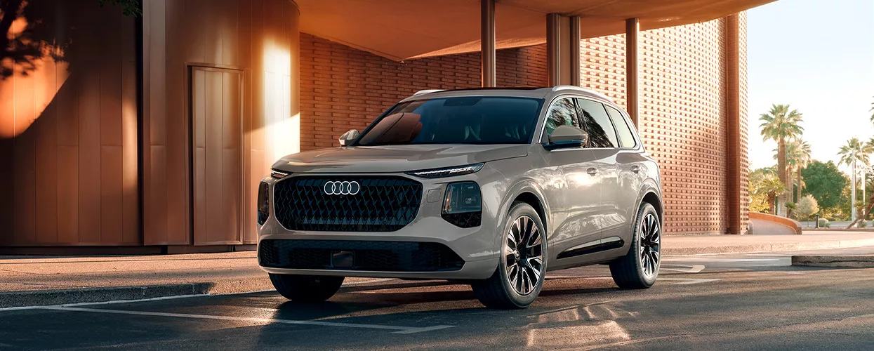 2027 Q7 parked in front of a building