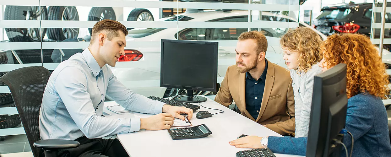Customer reviewing Ford Credit financing options with a Bob Bell Ford advisor