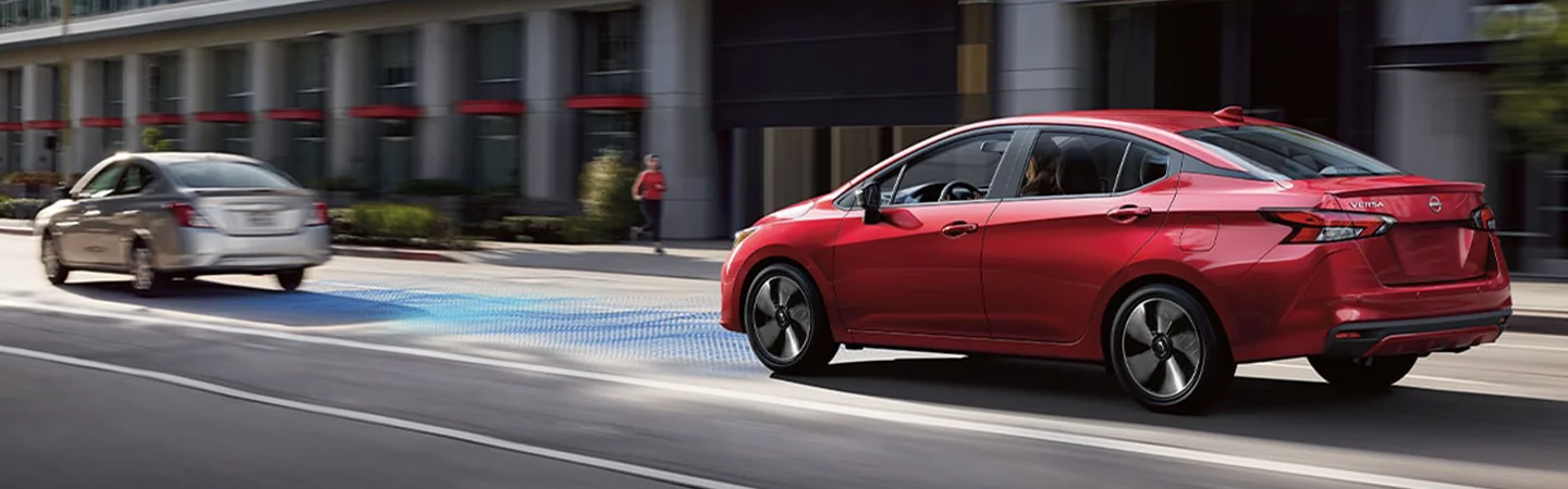 2024 Nissan Versa Specs side front in silver and red 