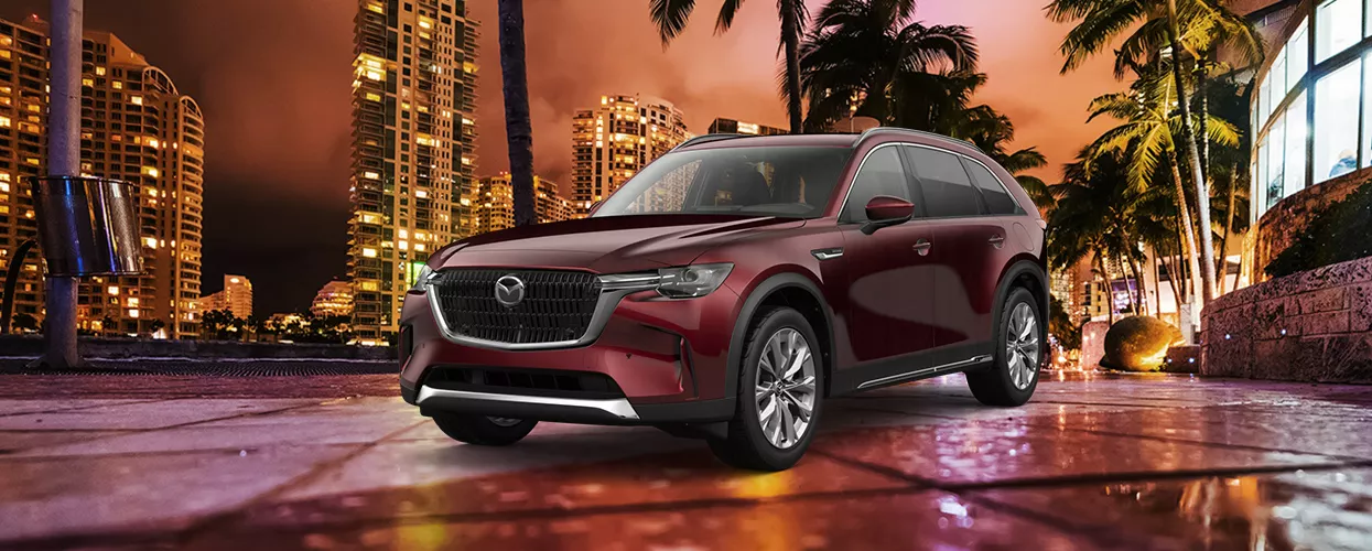 Mazda parked with a city background