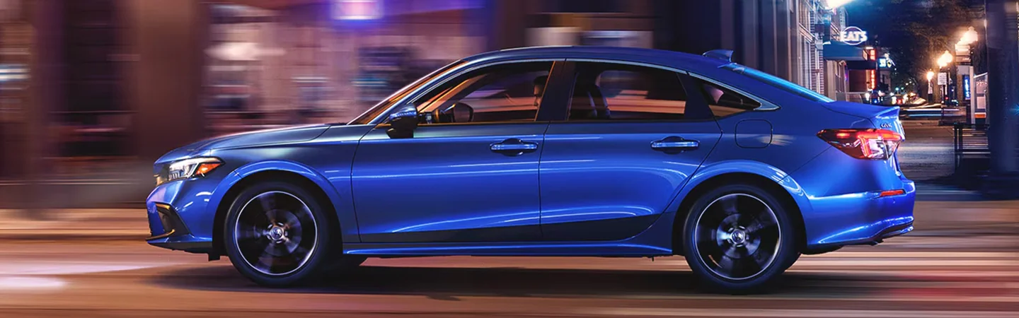 2024 Honda Civic vs Toyota Corolla side front in blue