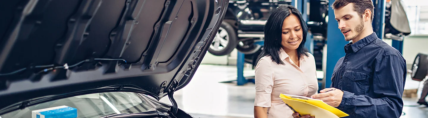 mechanic explaining the service to the female owner