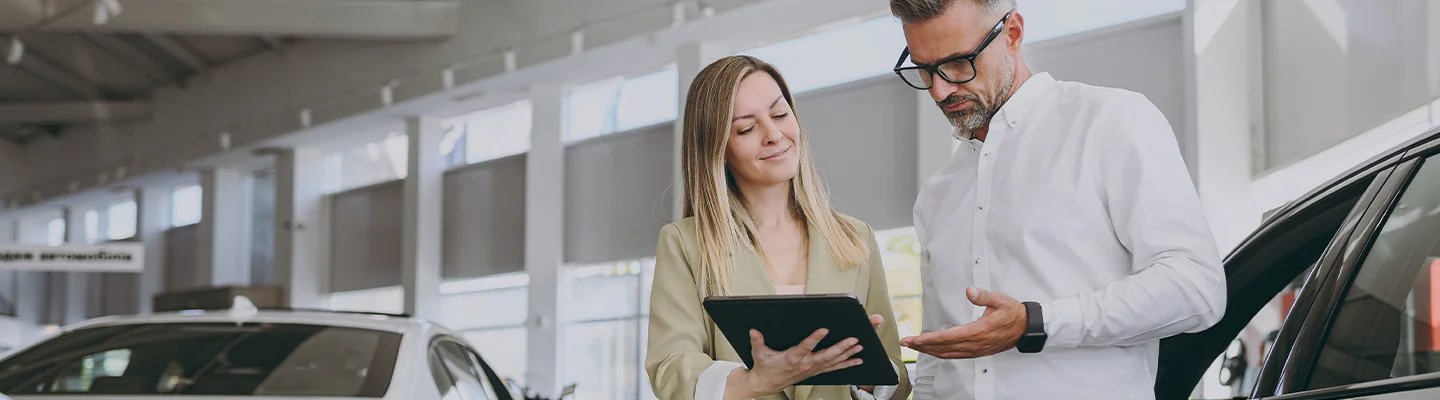 Salespeople discussing a vehicle at a dealership