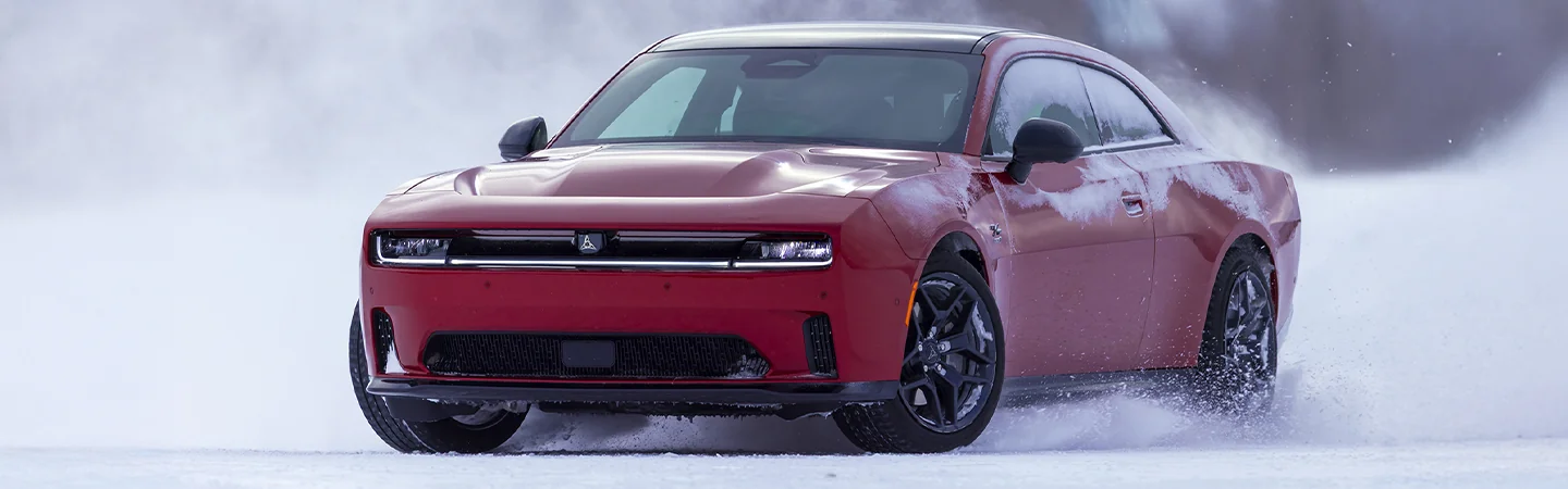 Red 2025 Dodge Charger driving thought the snow